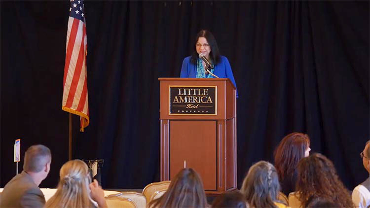 Barbara Rubel on stage at a speaking conference